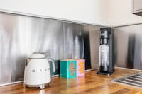 a kitchen with a coffee maker and a kettle