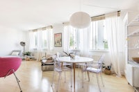 a living room with a table and chairs