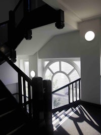 a black stairway with a window in the middle